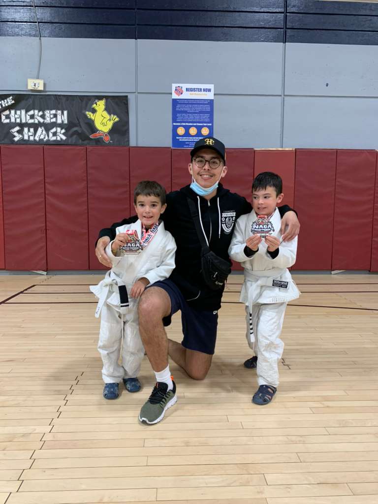 Xavier with young students holding competition medals